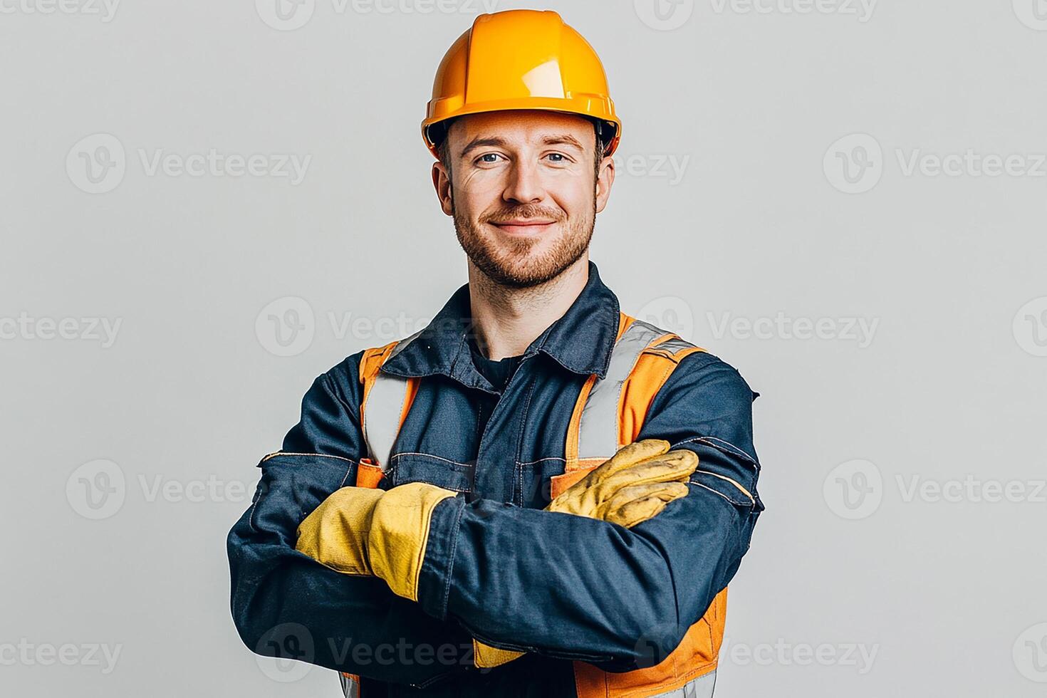 Portrait of a smiling man in work clothes standing with his arms crossed photo