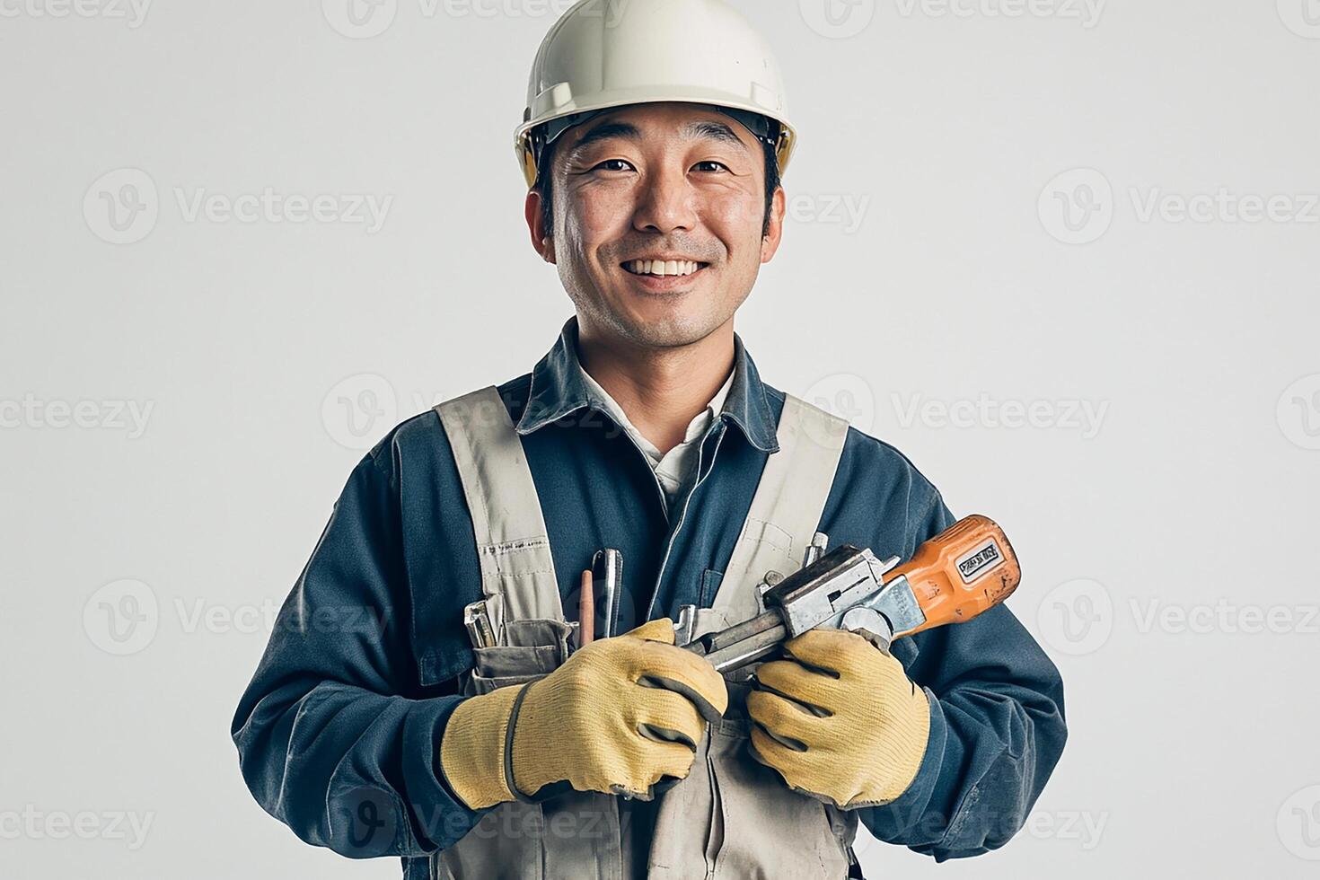 Asian male construction worker holding a drill photo