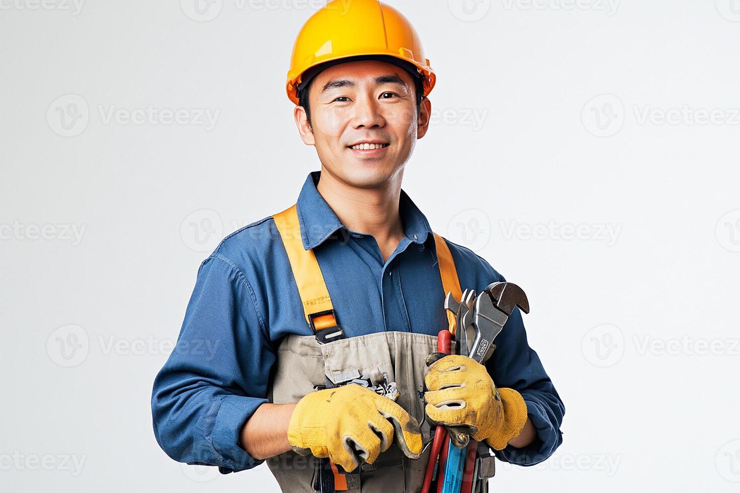 Asian male construction worker holding tools photo