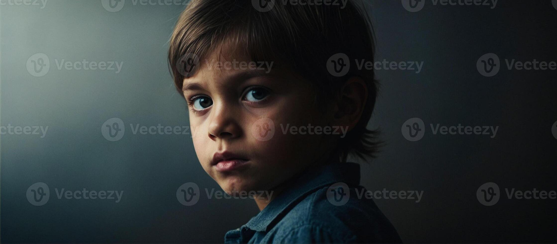 A young boy stares into the camera photo