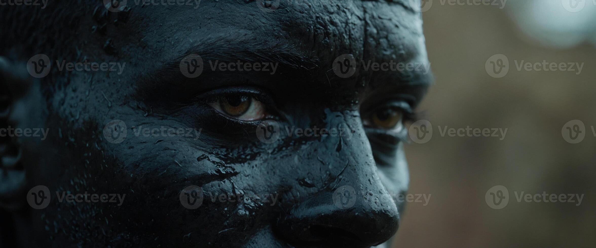 A close up of a black man's face with a lot of mud on it photo