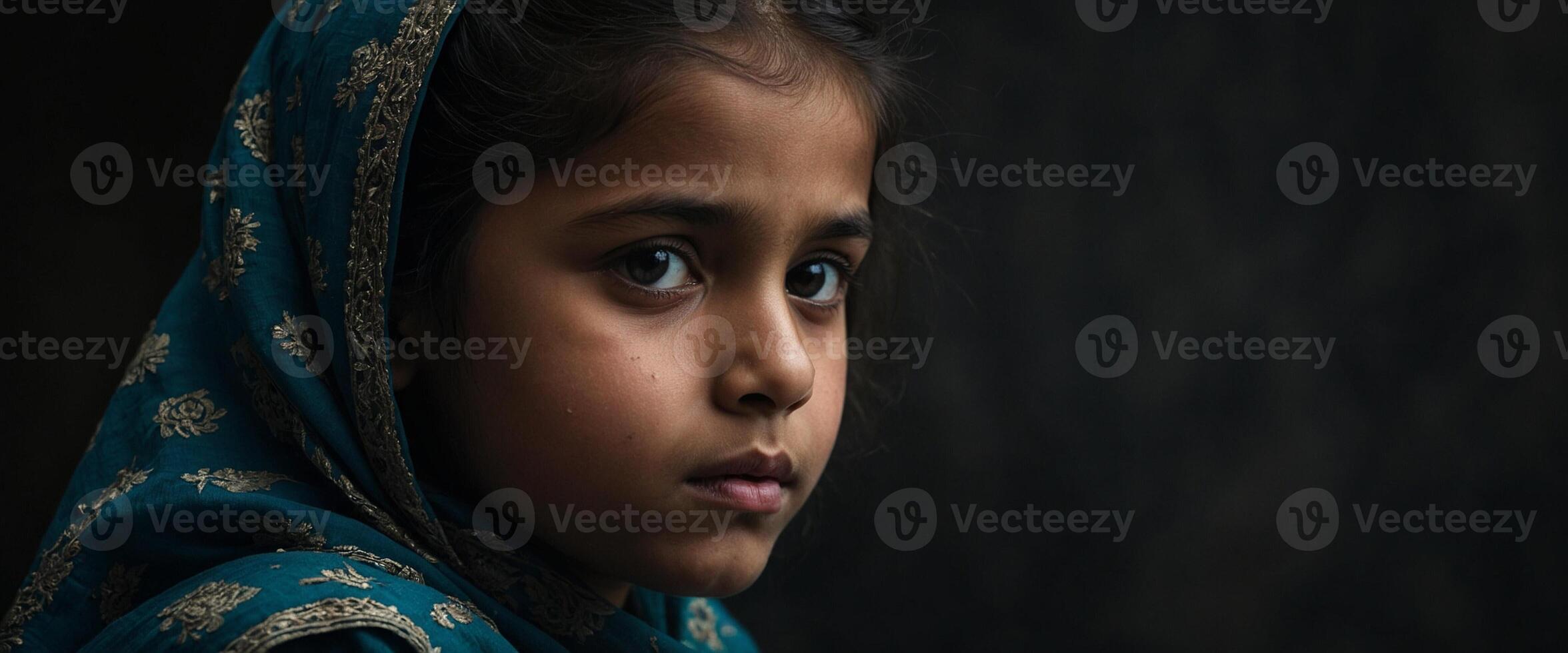A young girl in a blue shawl photo