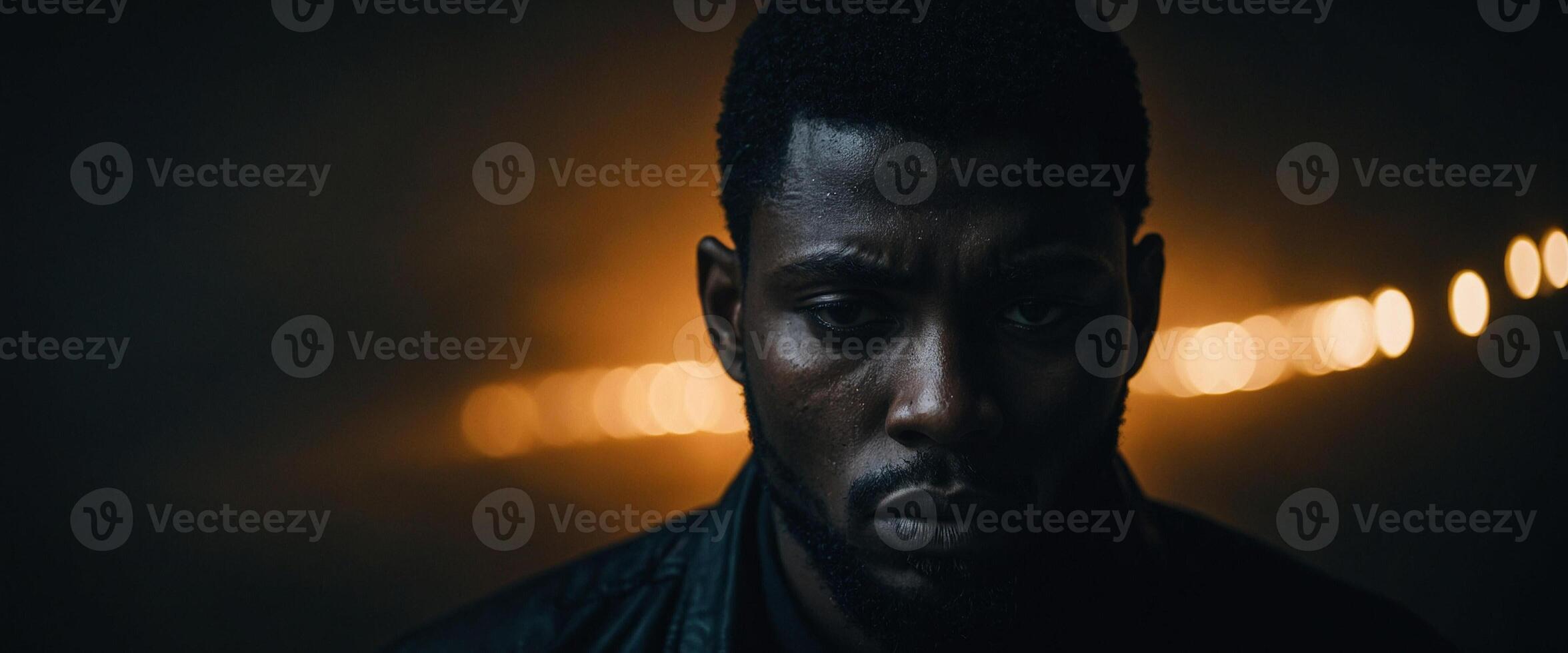 A man with a beard and dark background photo