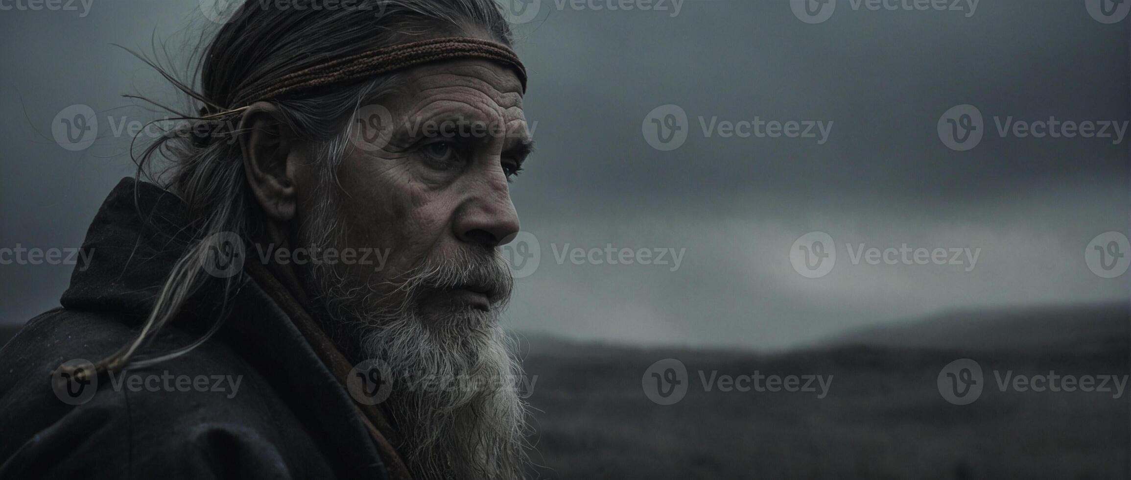 The man with long hair and beard in the dark photo