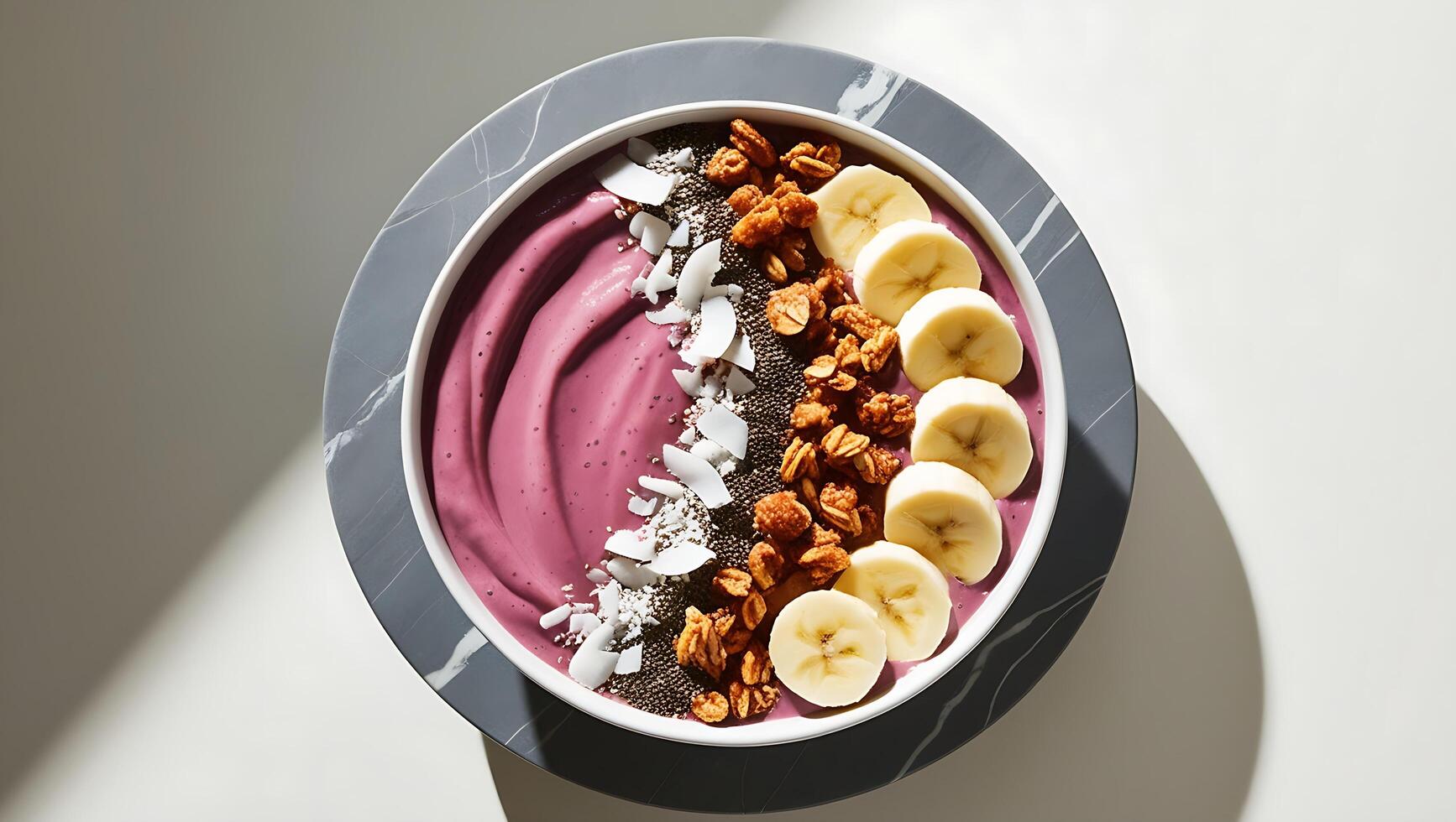 A bowl of purple smoothie with bananas, nuts and coconut photo