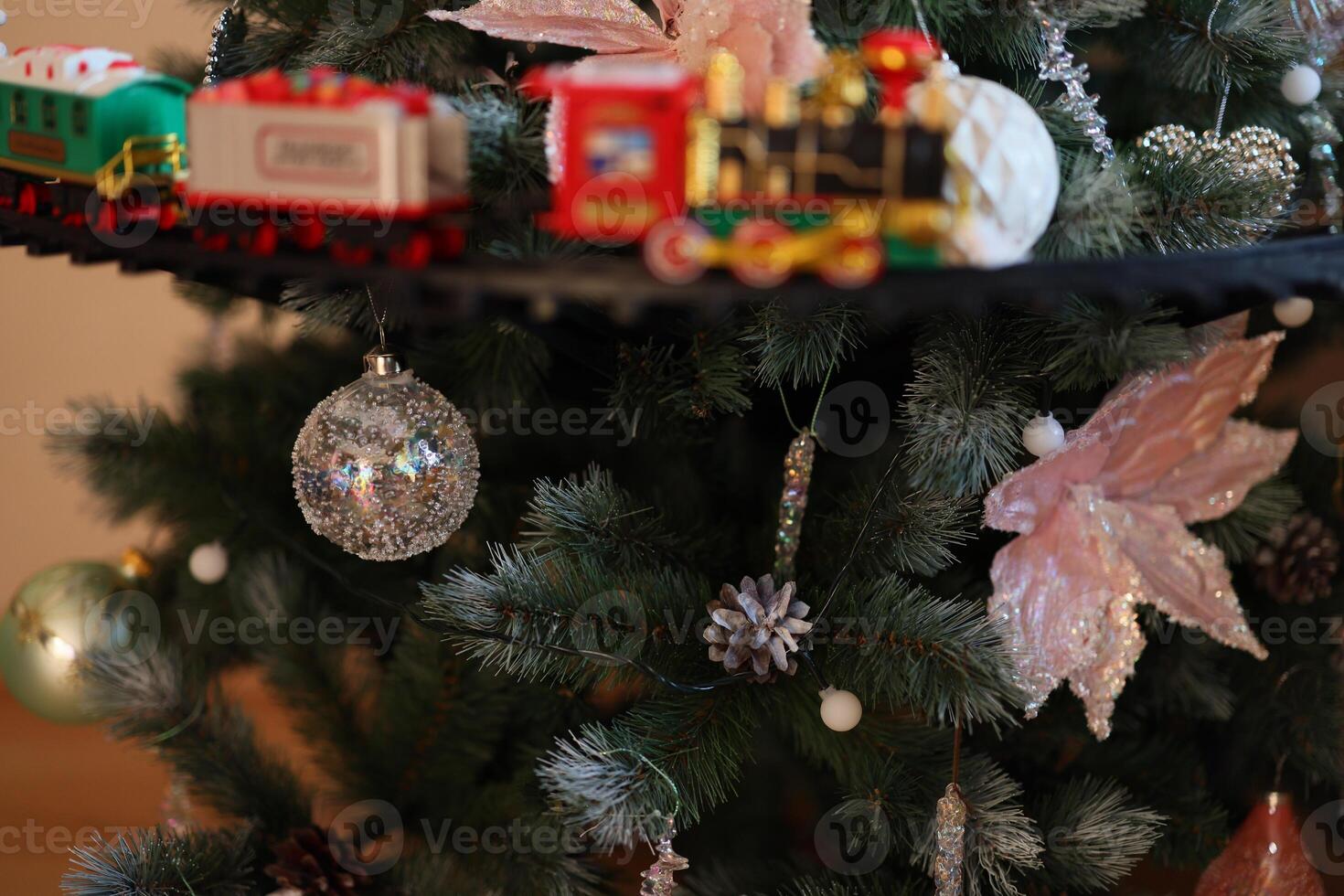 A beautifully festive Christmas Tree adorned with a Colorful Train and delightful Ornaments photo