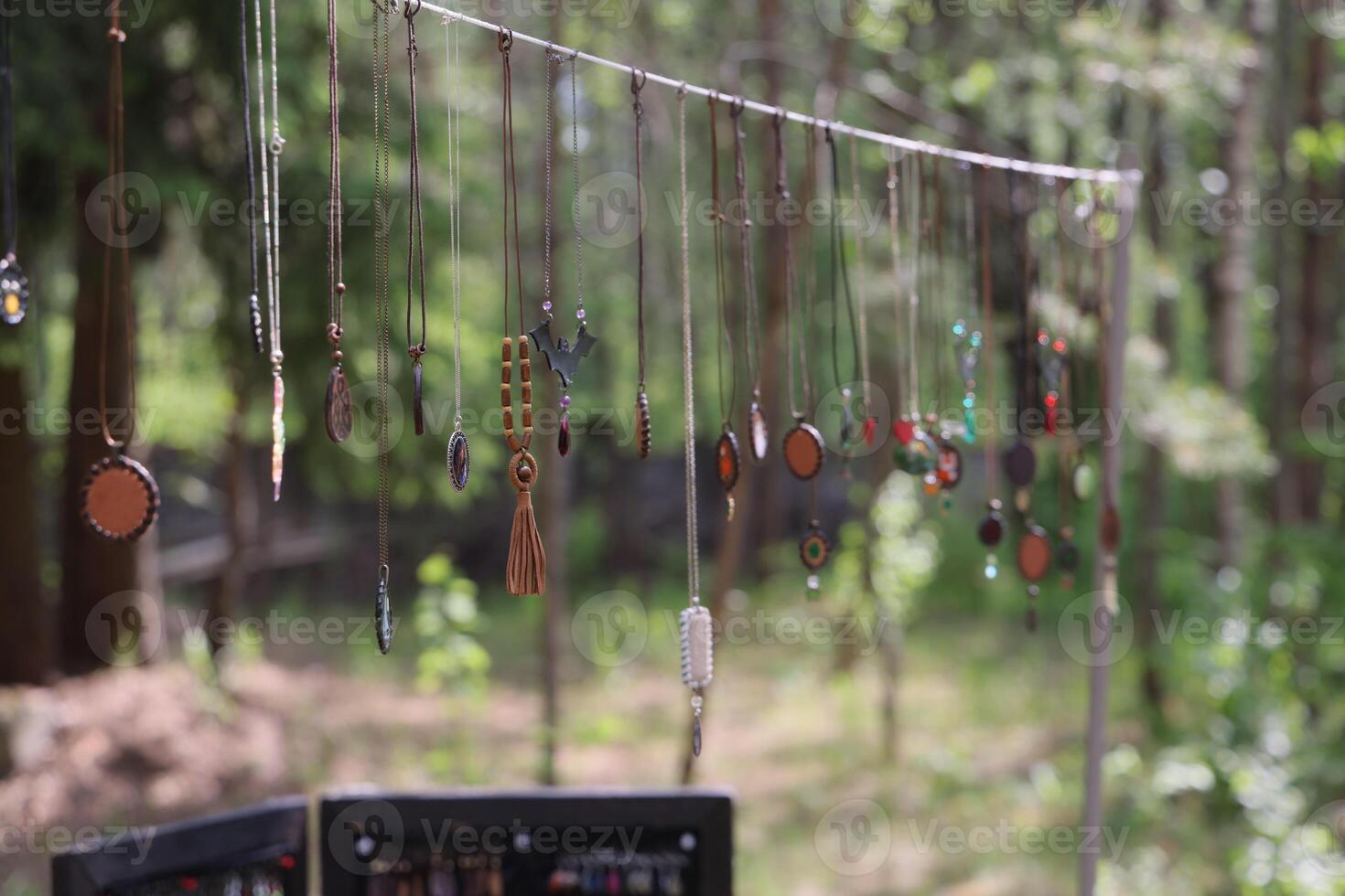 A Beautiful Hanging Jewelry Display Set in a Stunning Nature Setting for Inspiration photo