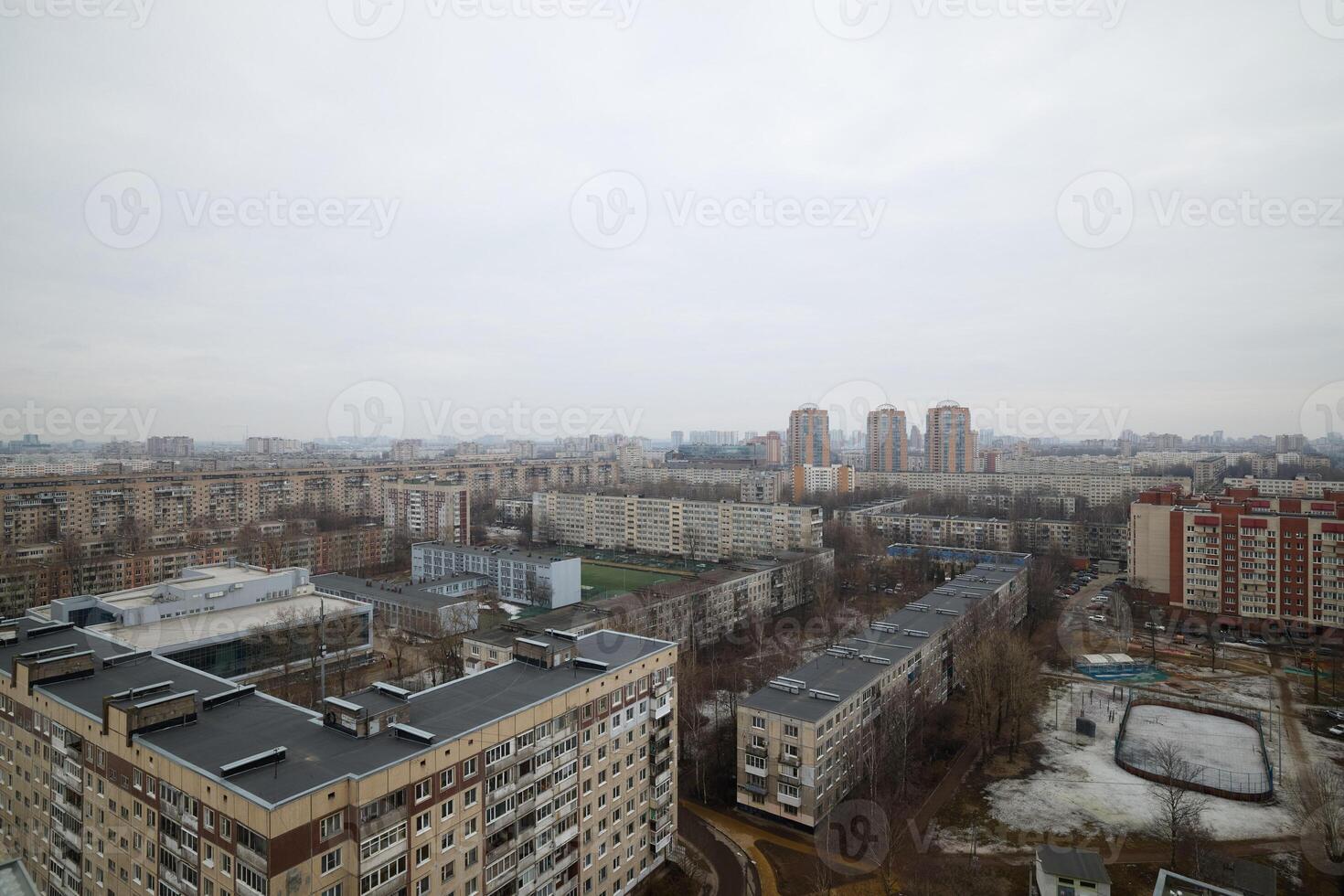 Urban Landscape Featuring Overcast Sky Alongside Various Residential Buildings and Structures photo