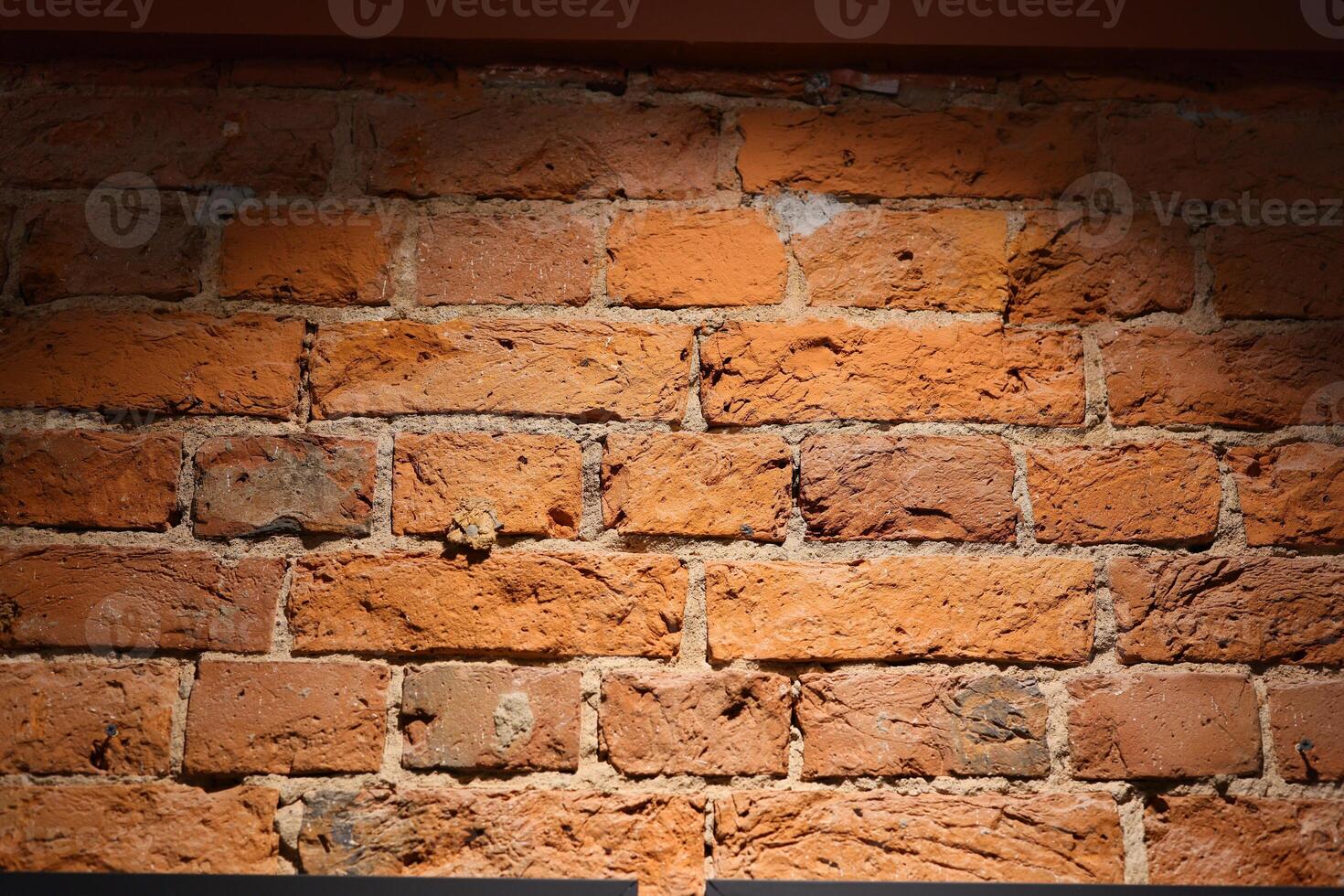 An UpClose Perspective of a Beautiful Rustic Red Brick Wall Illuminated by Natural Light photo