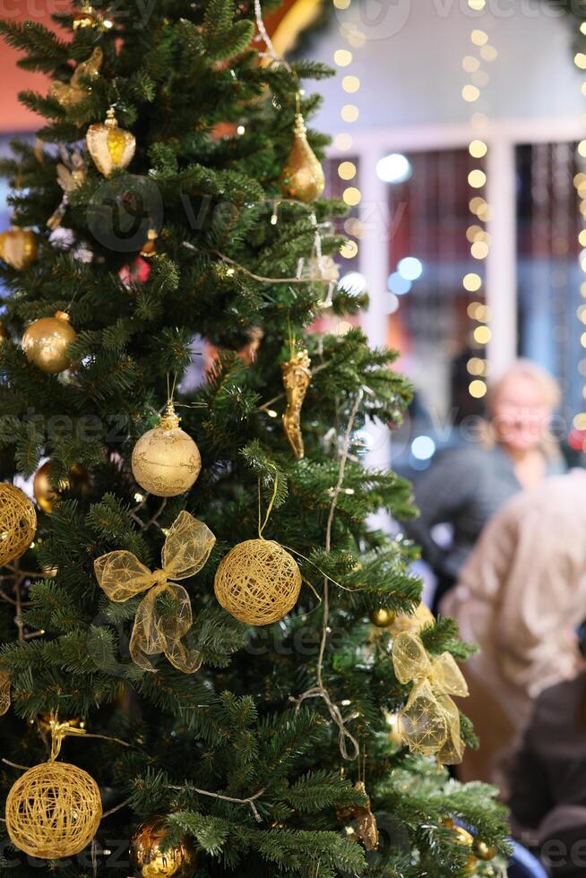 A festive Christmas tree decorated with sparkling golden ornaments, creating a cheerful vibe photo