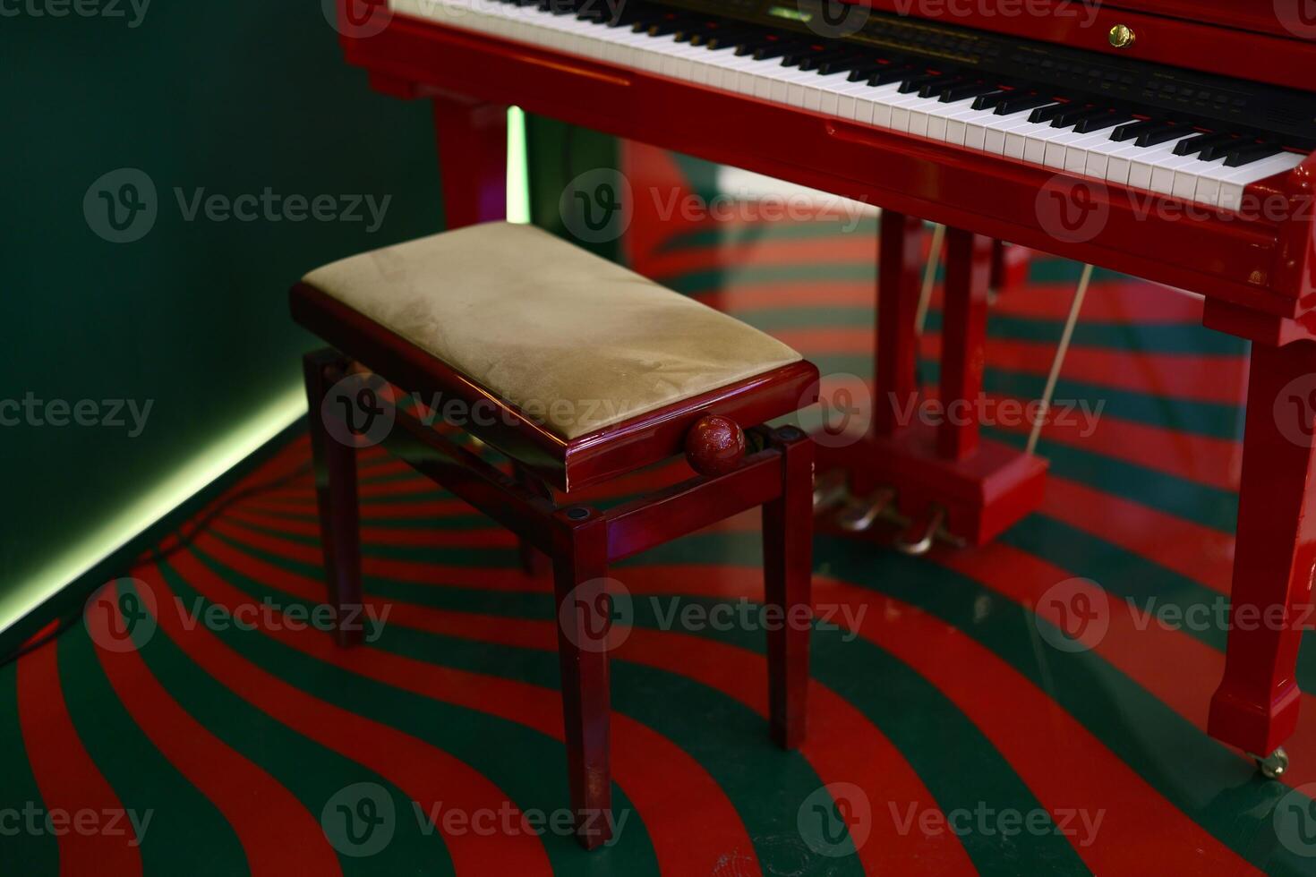 Beautifully Elegant Red Piano Paired with a Matching Bench in Unique and Artistic Interior Setup photo