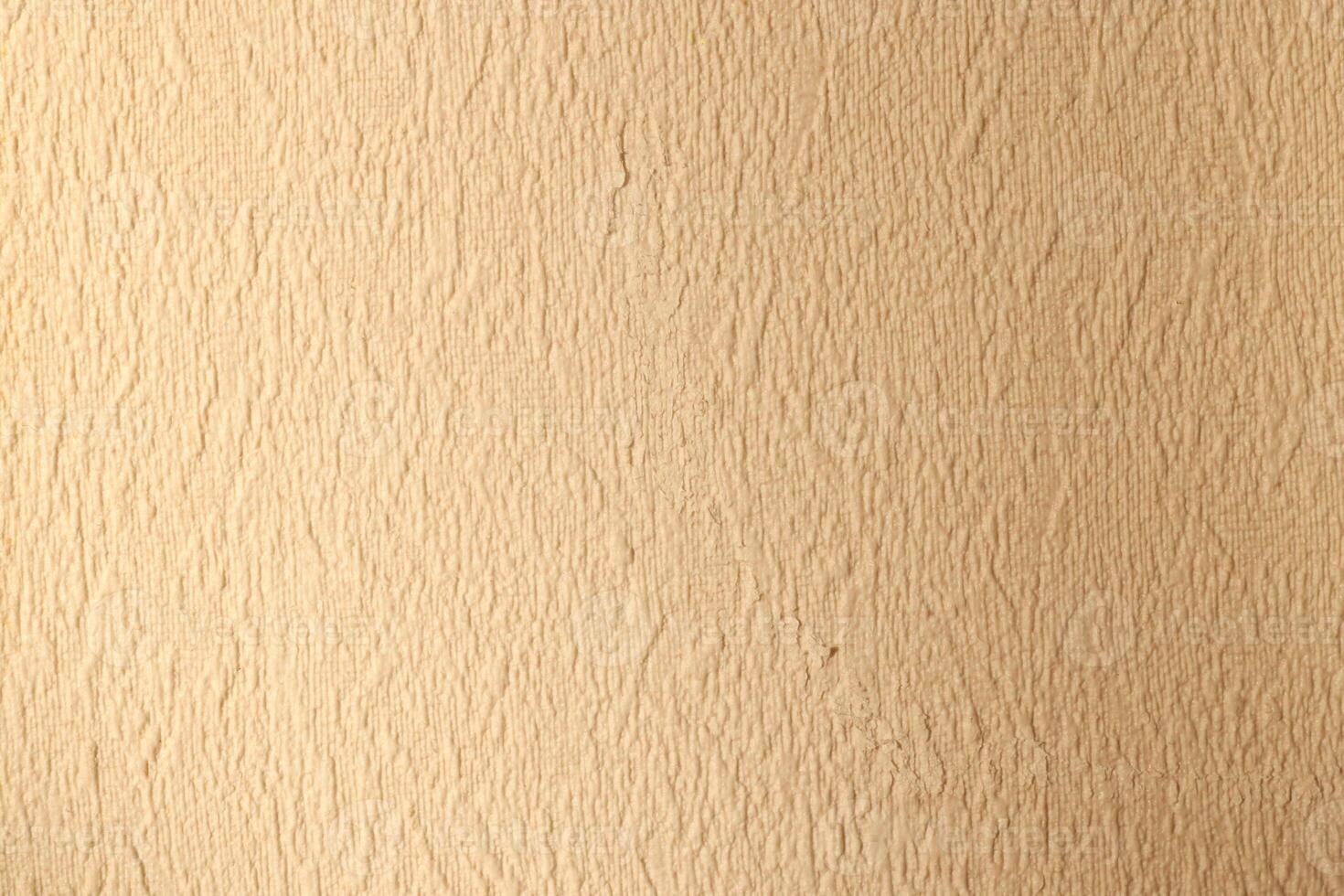 Textured Beige Wall Surface Ideal for Various Background Use in Design and Decor Projects photo