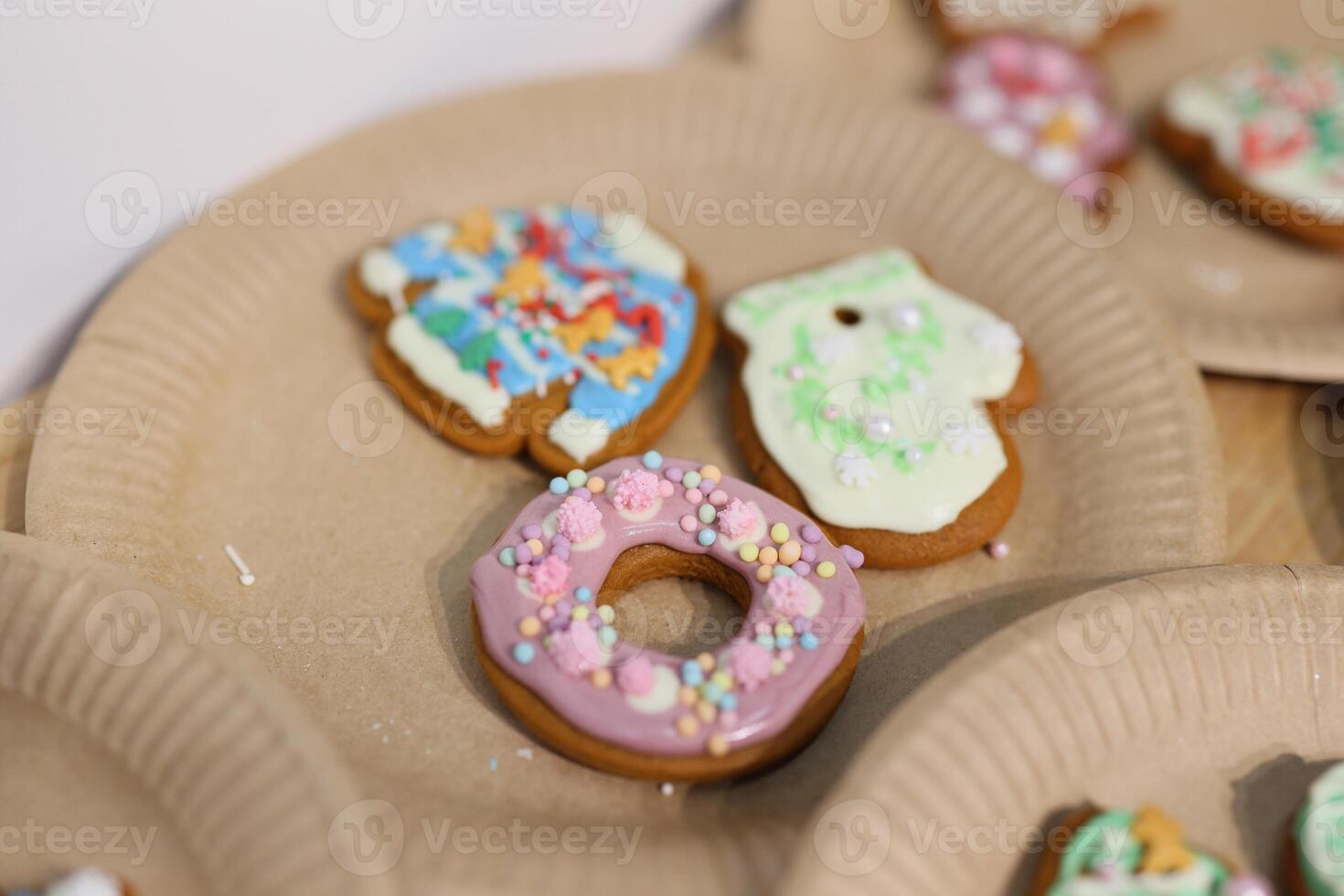 Vibrantly Colorful Decorated Cookies Displayed on Festive Paper Plates for Everyone to Enjoy photo