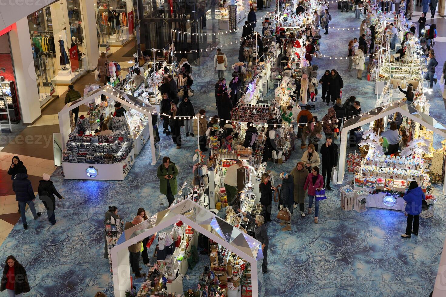 Busy Holiday Market filled with Excited Crowds in a Cheerful and Festive Indoor Space photo