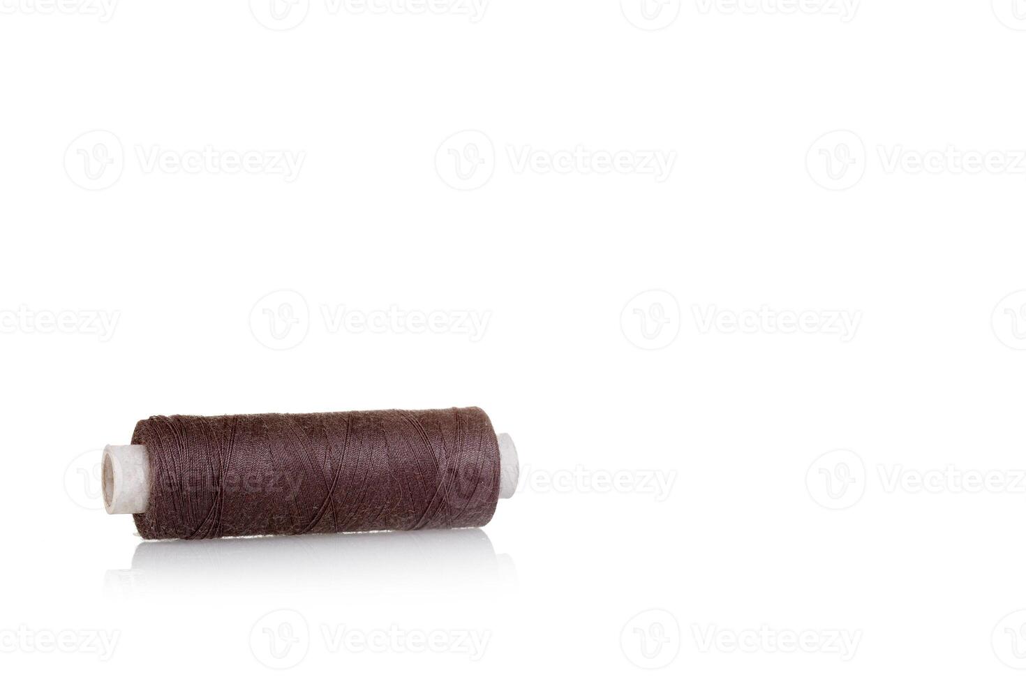 skein of thread brown colors macro on a white background photo