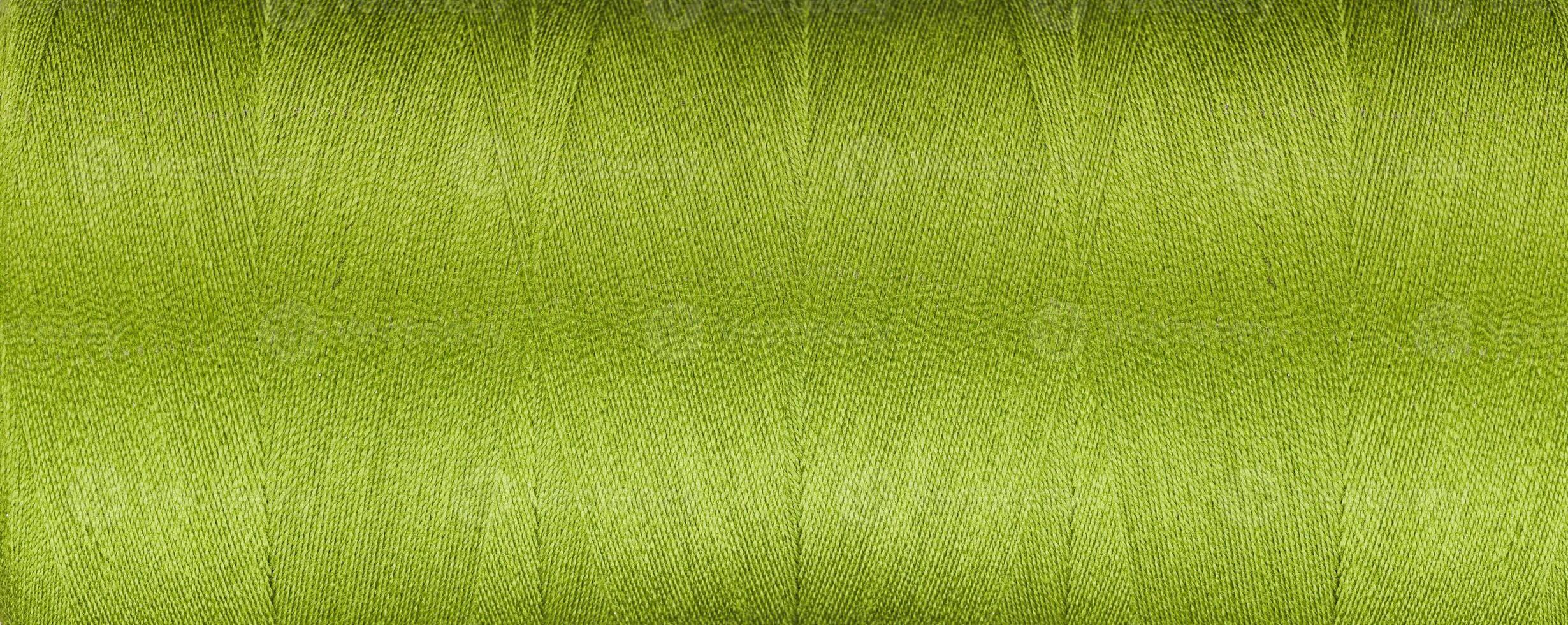 texture of thread for a sewing machine green color on a white background photo
