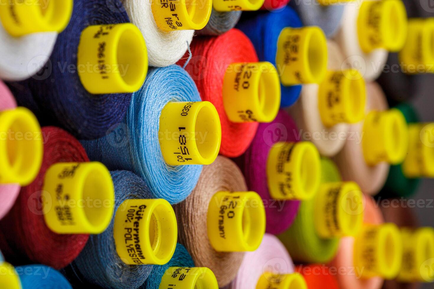 set of multi-colored spools of thread for sewing photo