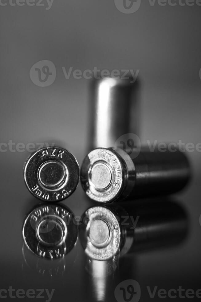 View of three pistol bullets in black and white photo