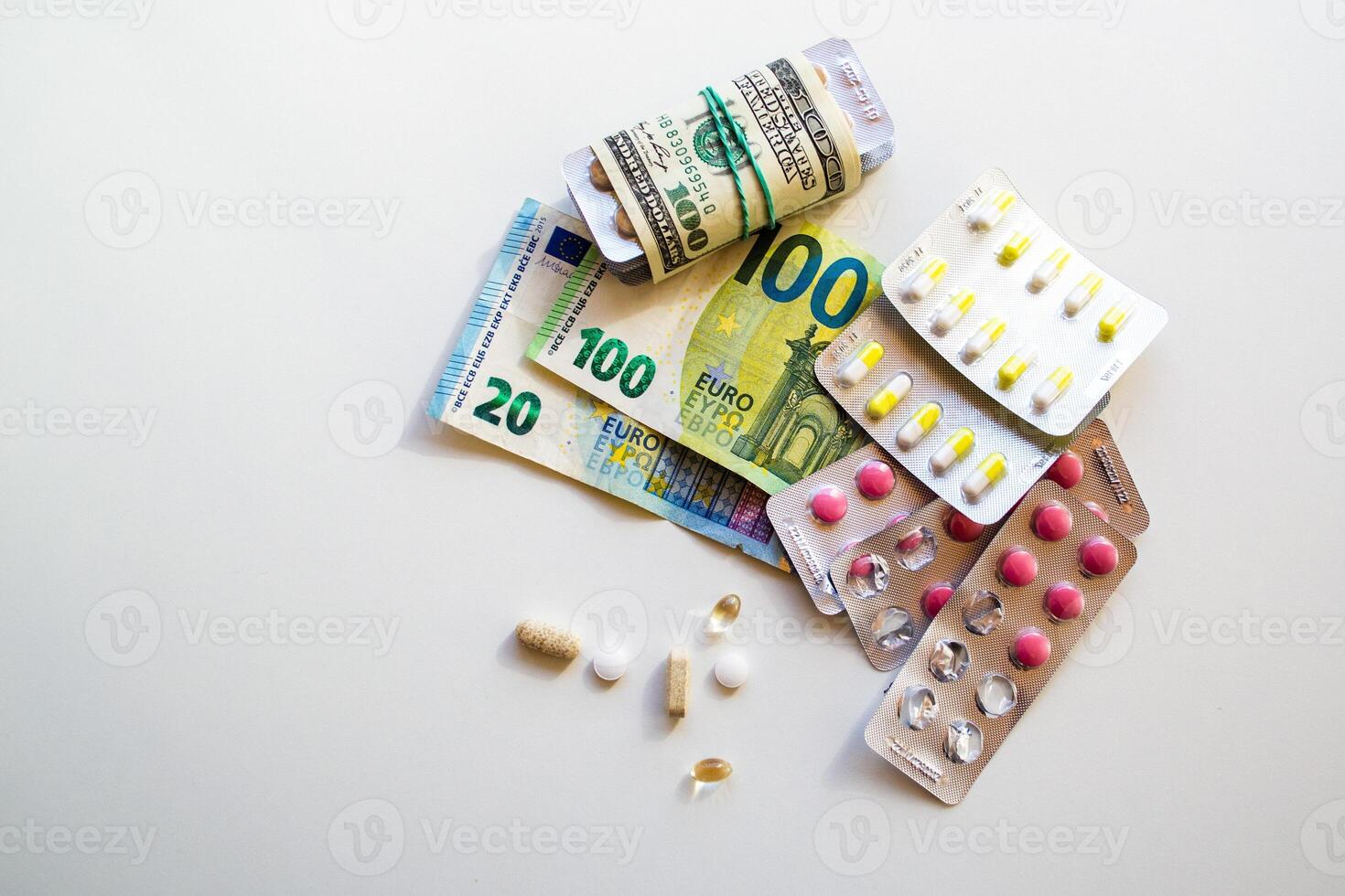 Jelly capsules and hard tablets of vitamin D on dollar bills on a white table photo