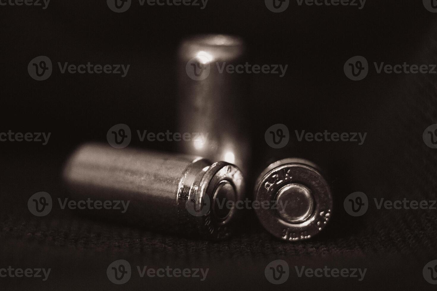 View of three pistol bullets in black and white photo