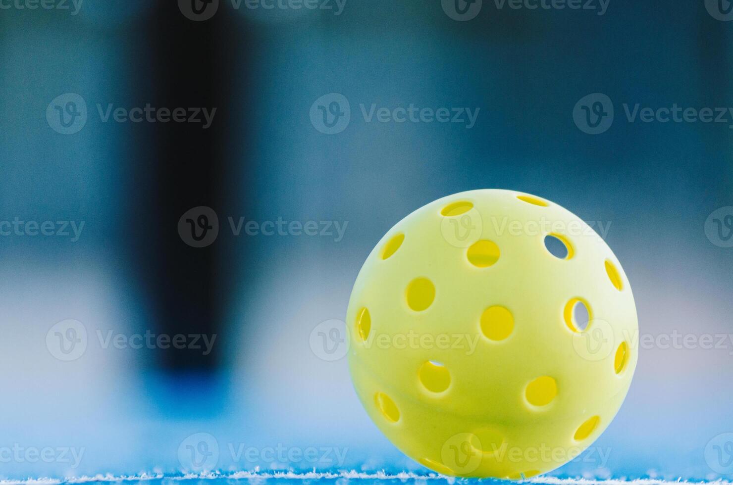 lone pickleball ball in a pickleball court, racket sports background photo