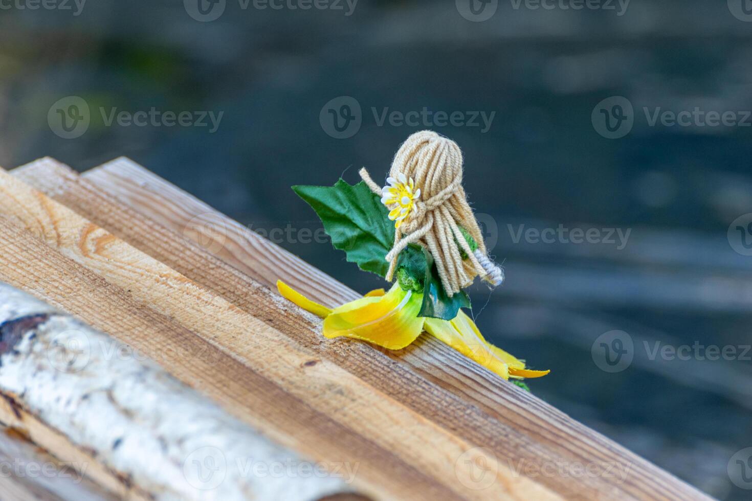 a homemade toy fairy sitting on the wooden roof of a house in a christmas decoration photo