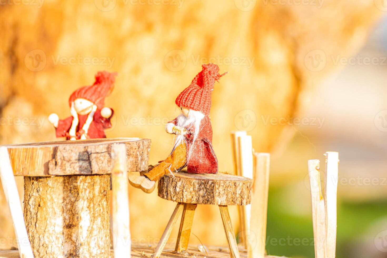 a red dressed elves sitting in a fairy village of homemade handmade christmas decoration photo