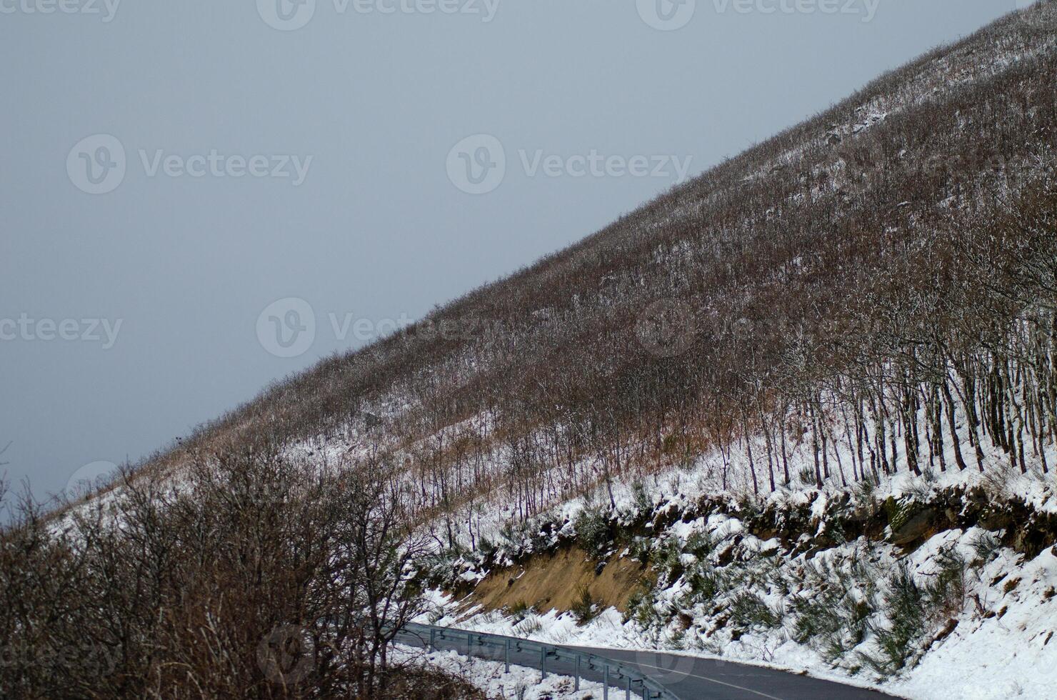 road on a snowy mountainside in the wintertime, concept of winter background photo