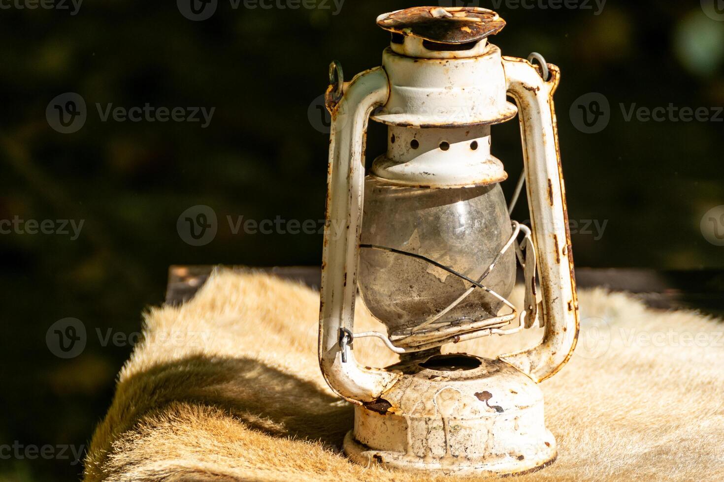 old and rusty candle on an animal skin, decoration for historical parties photo