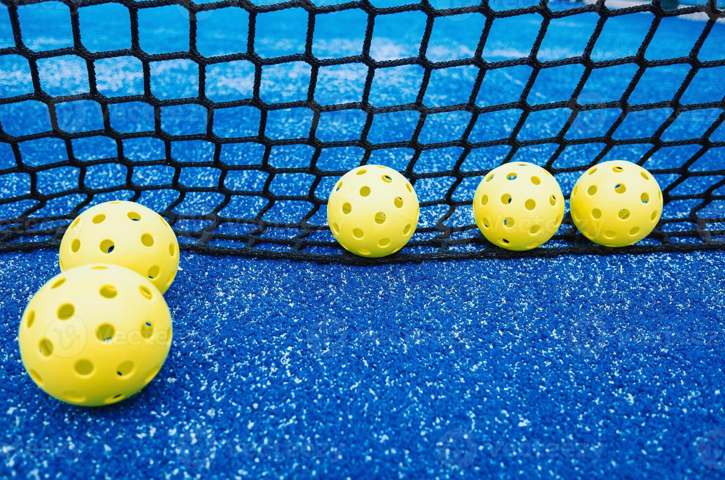 pickleball balls near the net on a pickleball court, racket sports background photo