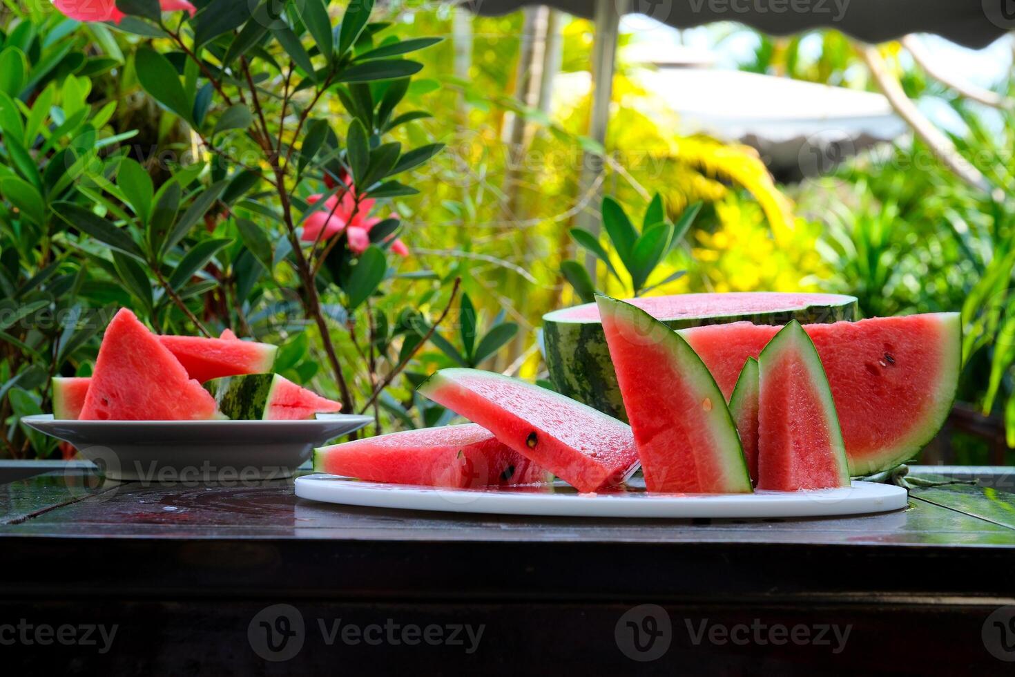 Slices of ripe watermelon on wooden table close up photo