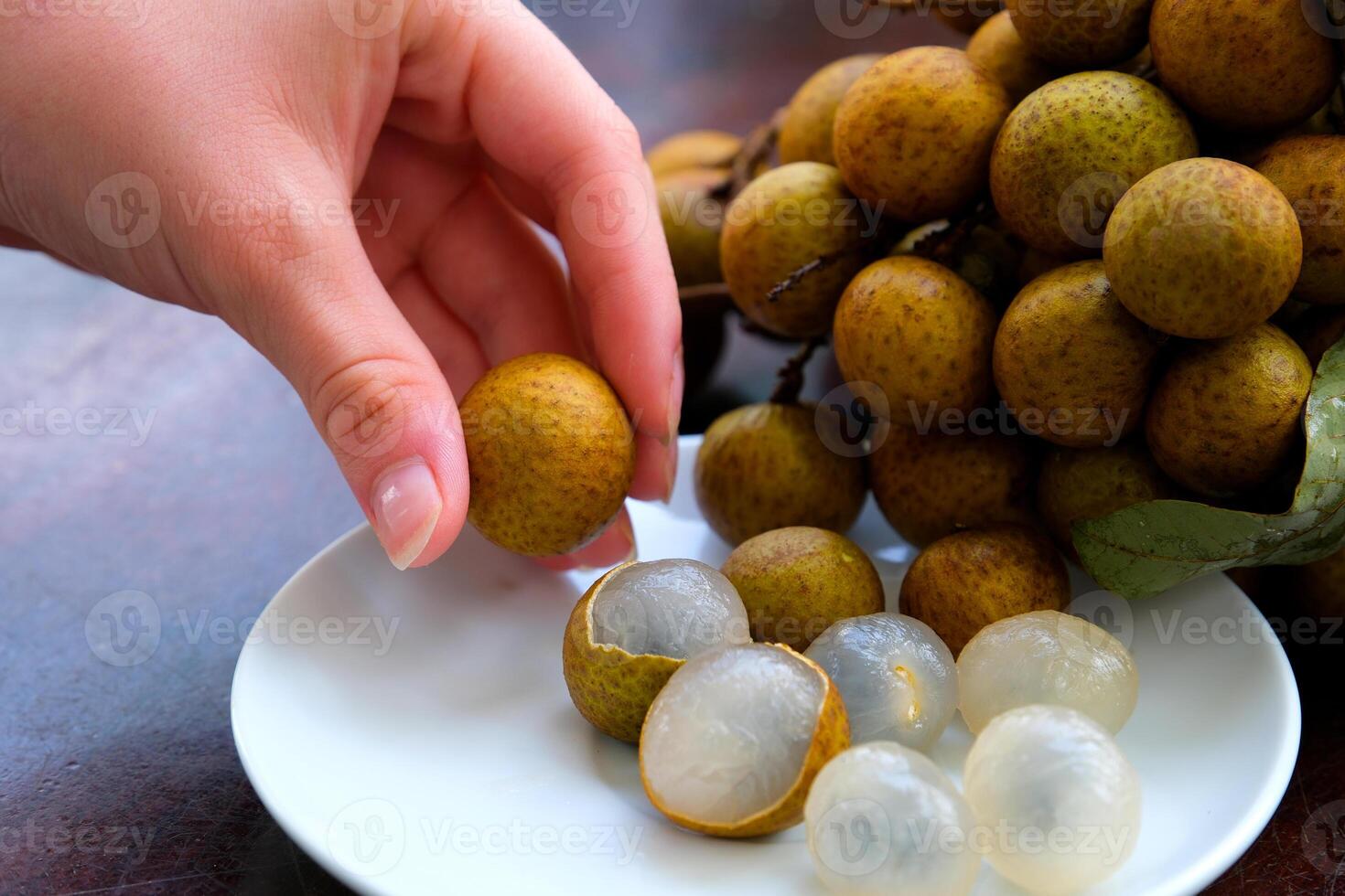 longan fruit on a white round plate isolate on white background photo