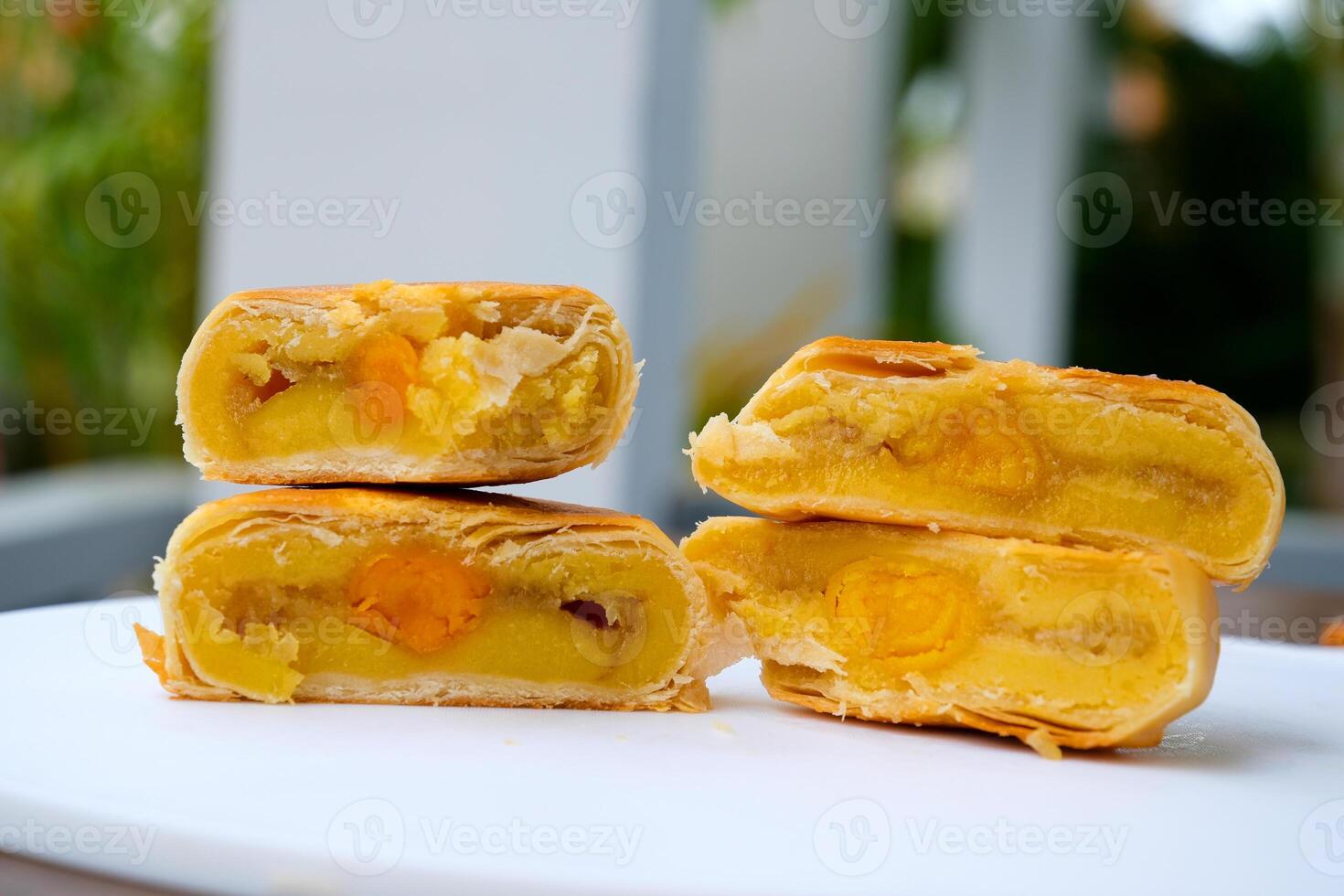 High angle view of whole and two halves chinese pastry or moon cake filled with sweet mung bean paste and salted egg yolk. photo