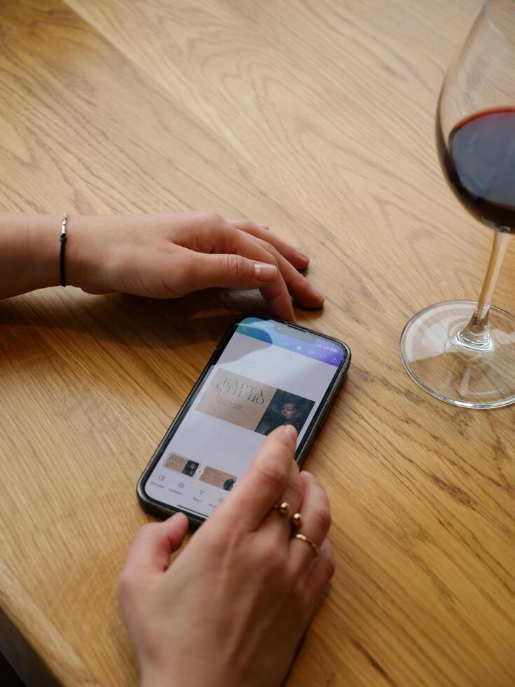 A person using an iphone to view a wine app photo