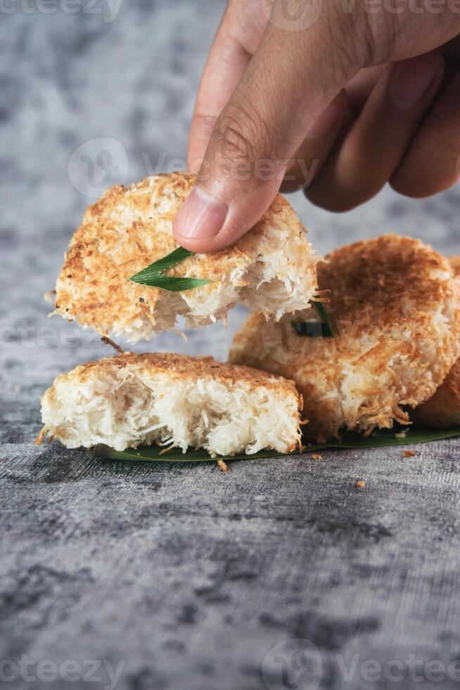 Indonesian Traditional Coconut Cake called Sagon on Banana Leaf with Rustic Background Setting photo