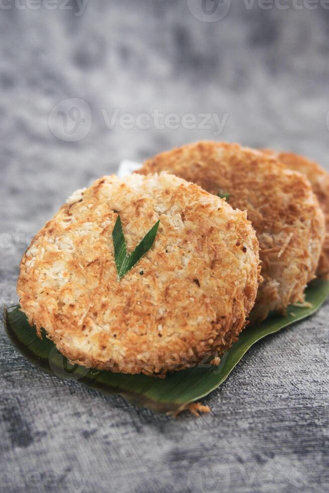 Indonesian Traditional Coconut Cake called Sagon on Banana Leaf with Rustic Background Setting photo