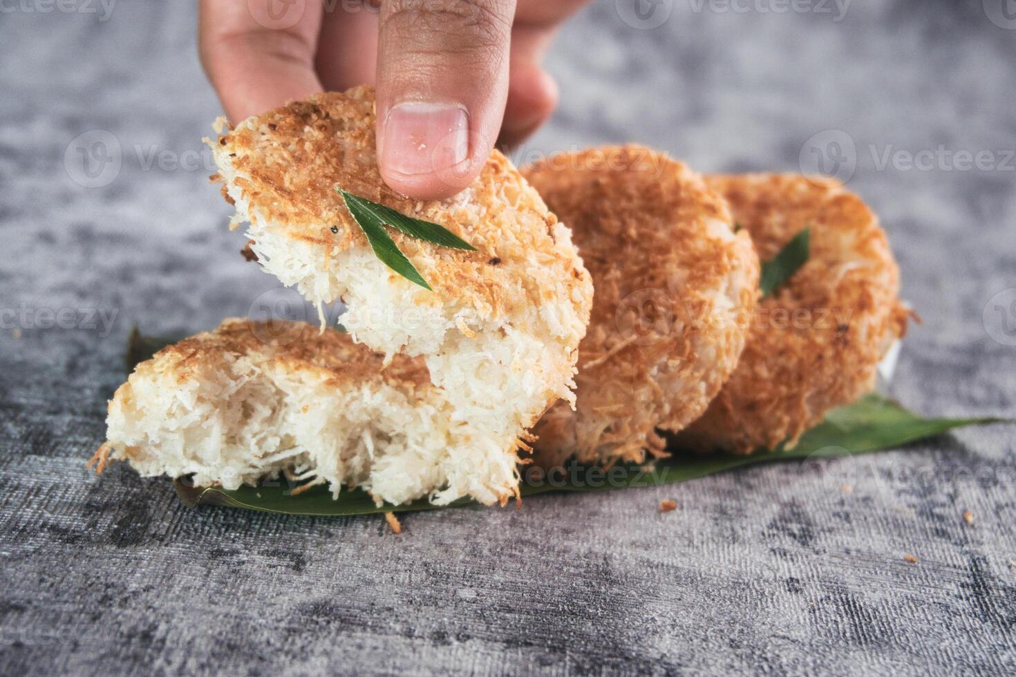 Indonesian Traditional Coconut Cake called Sagon on Banana Leaf with Rustic Background Setting photo