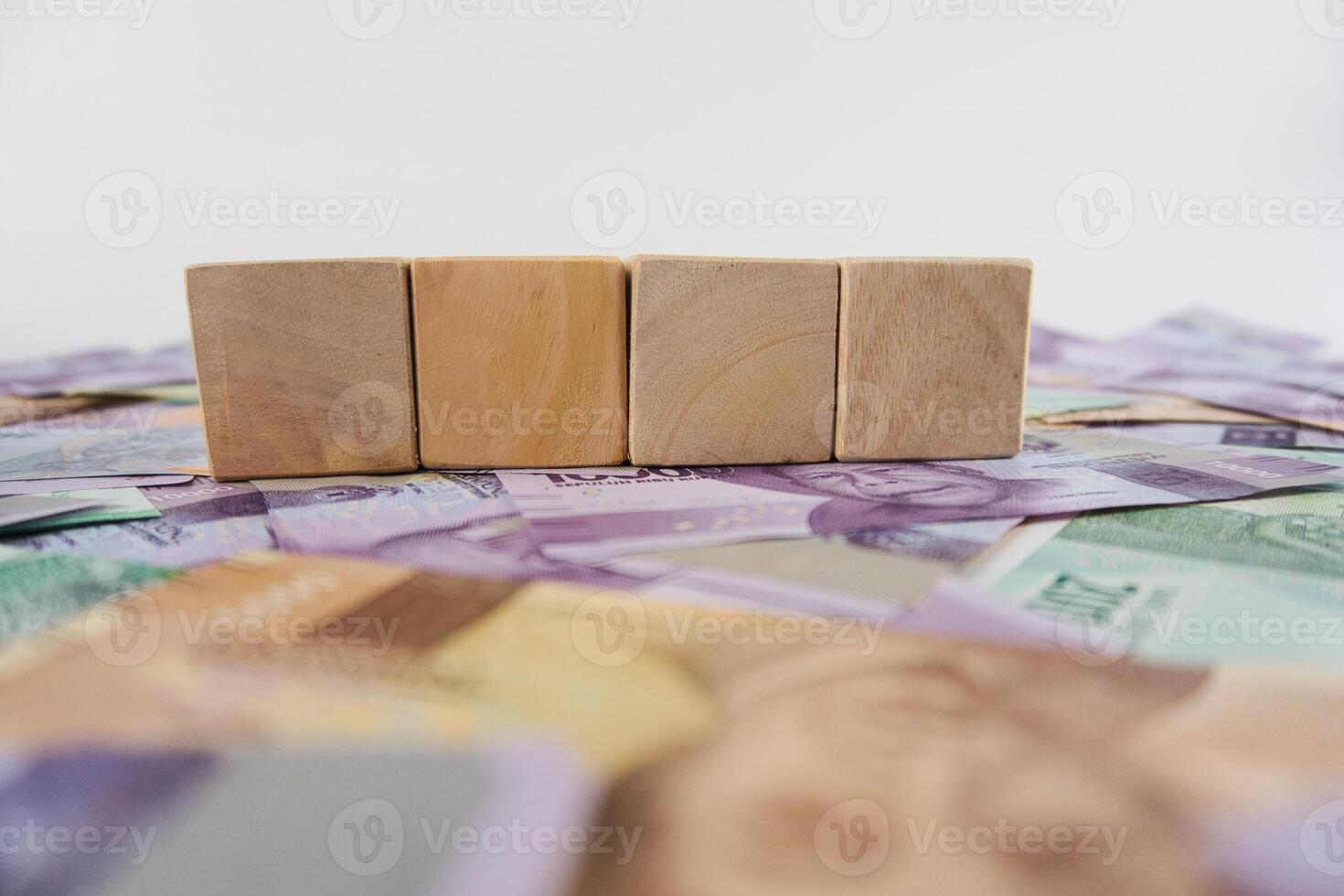 Wooden Blocks Over Banknotes Depicting Financial Planning and Investment Concepts photo
