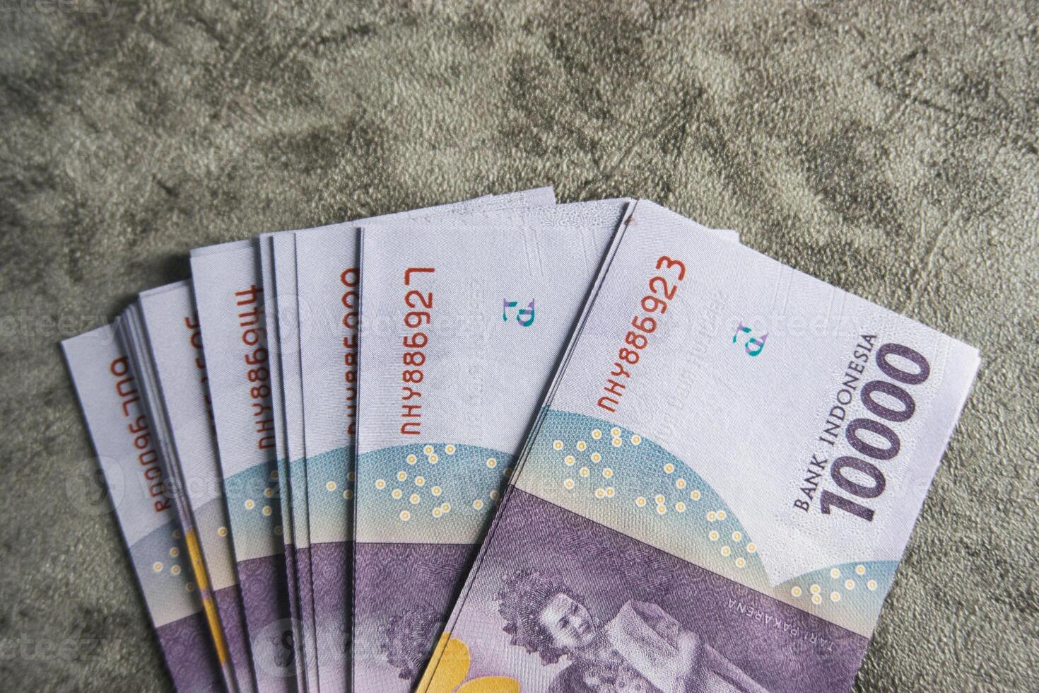 Indonesian Rupiah Fan Arrangement on Textured Surface photo
