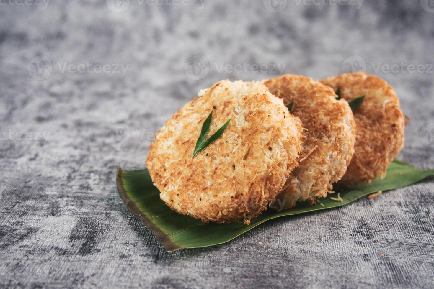 Indonesian Traditional Coconut Cake called Sagon on Banana Leaf with Rustic Background Setting photo