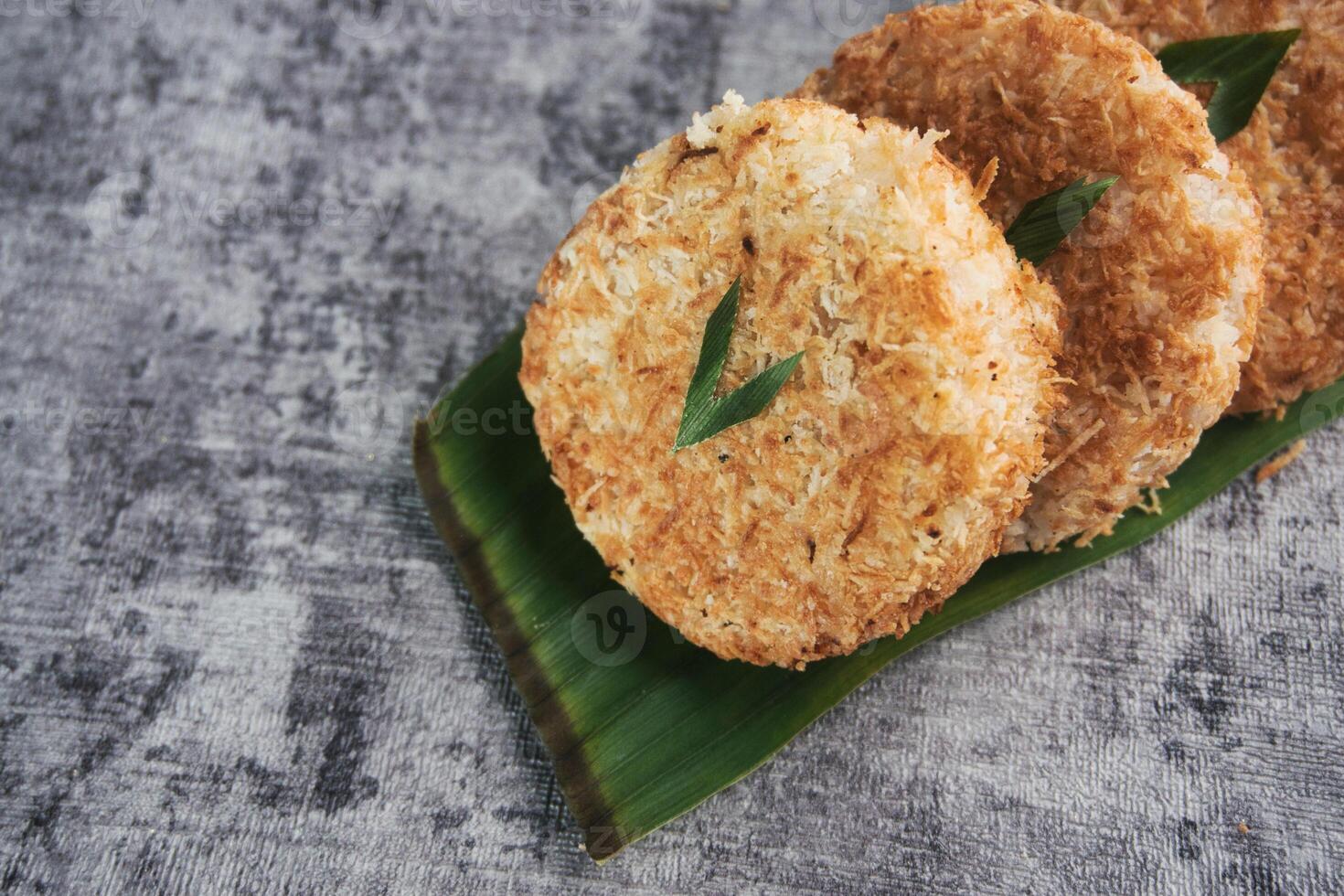 Indonesian Traditional Coconut Cake called Sagon on Banana Leaf with Rustic Background Setting photo