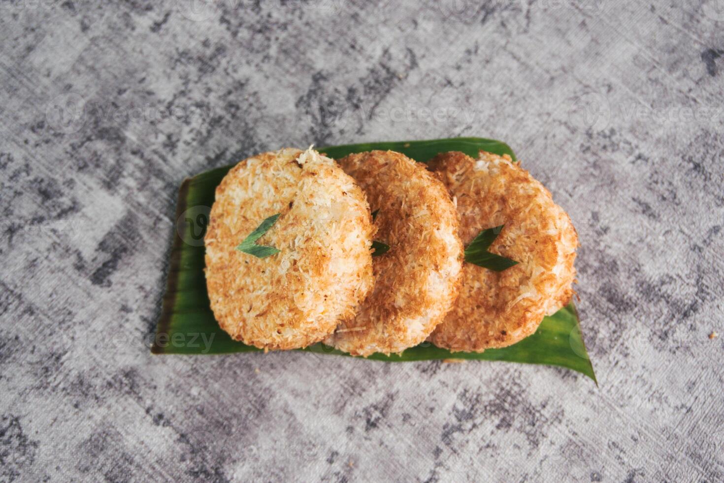 Indonesian Traditional Coconut Cake called Sagon on Banana Leaf with Rustic Background Setting photo