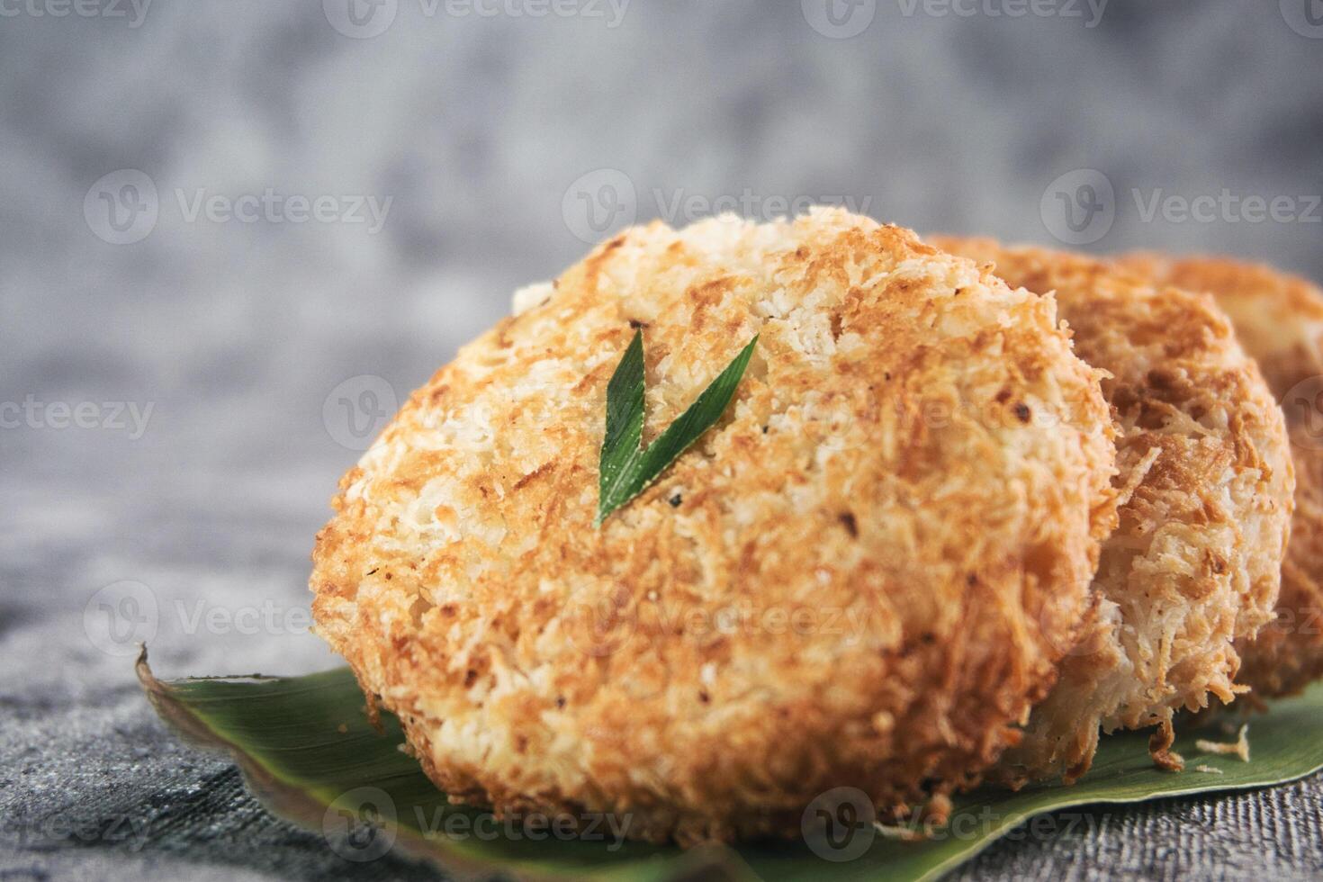 Indonesian Traditional Coconut Cake called Sagon on Banana Leaf with Rustic Background Setting photo
