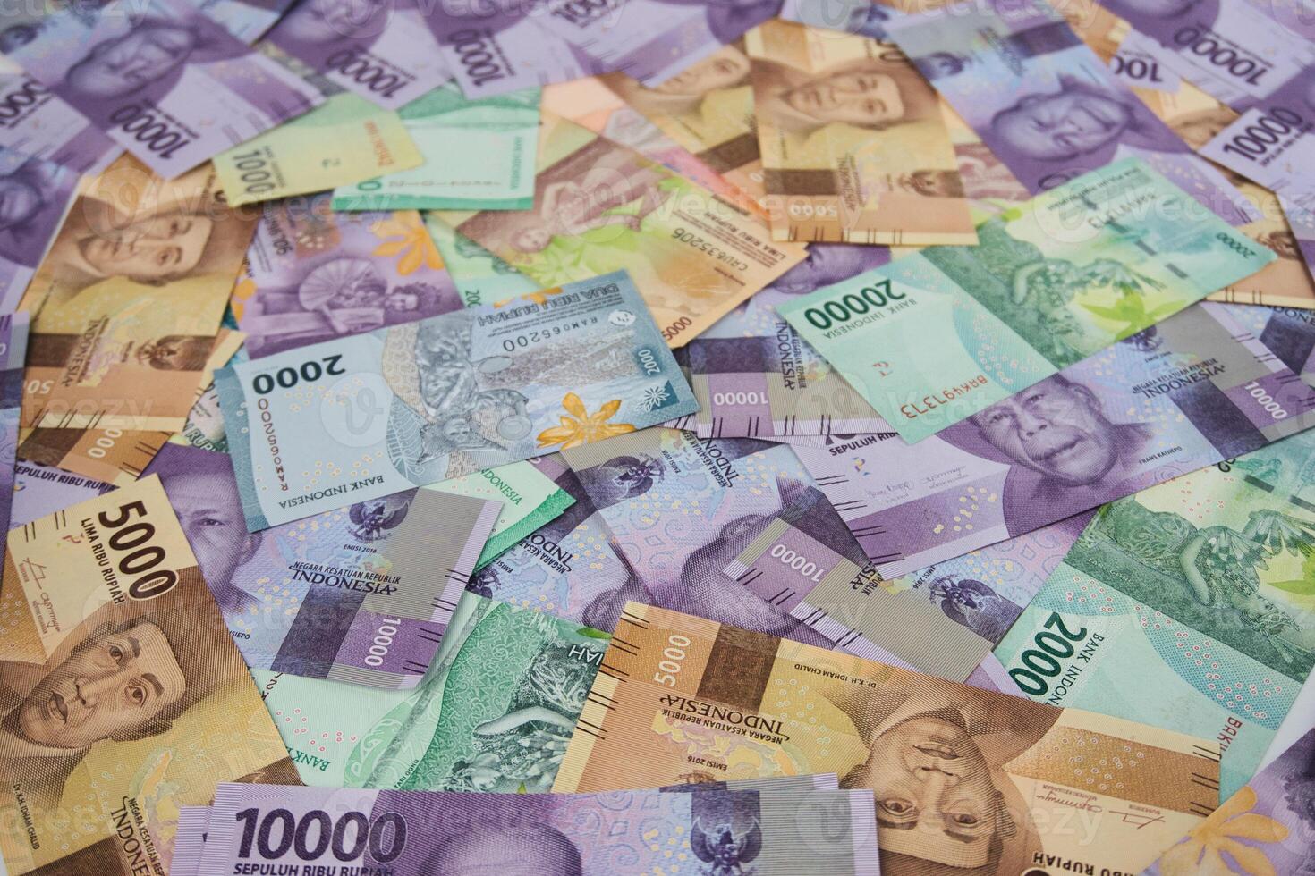 Various Colorful Indonesian Rupiah Banknotes Displayed in a Scattered Arrangement photo