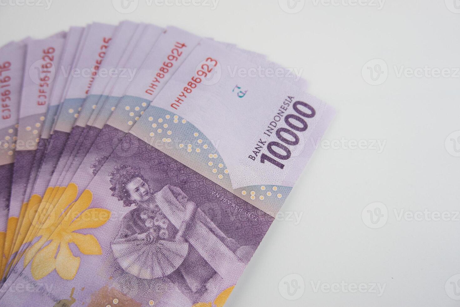 Indonesian Rupiah Banknotes Arranged in Ascending Rows on White Background photo