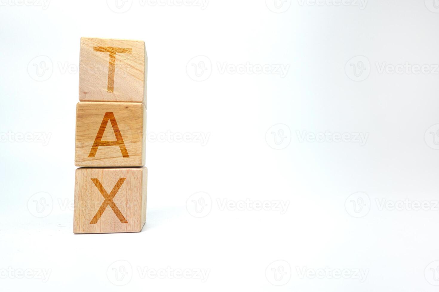 Wooden Blocks Spelling TAX with Minimalistic White Background photo