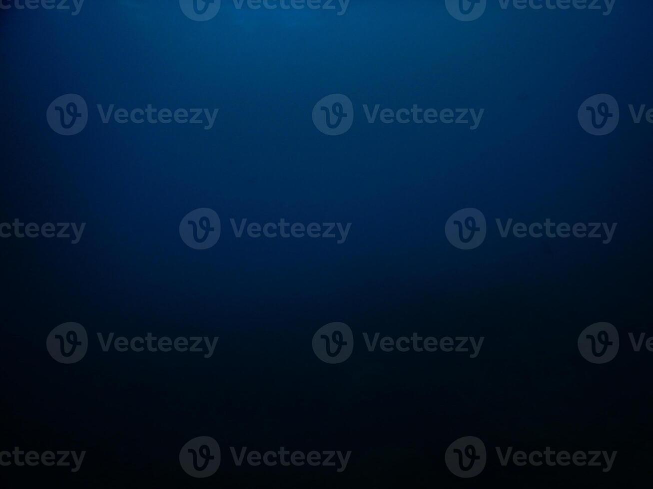 Dark blue degradation of view from deep sea, abstract background photo