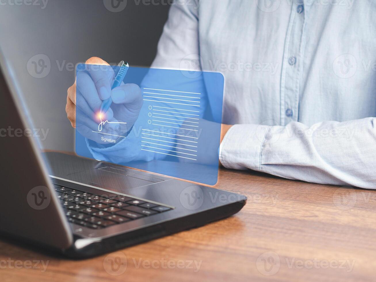 A businessman uses a pen to sign electronic documents on digital documents on a virtual screen photo