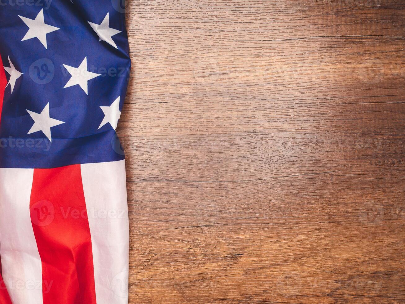 Top view of the American flag on a wooden table with copy space for text photo