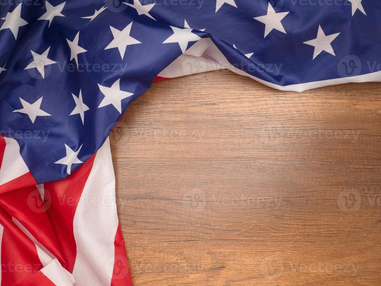 Top view of the American flag on a wooden table with copy space for text photo